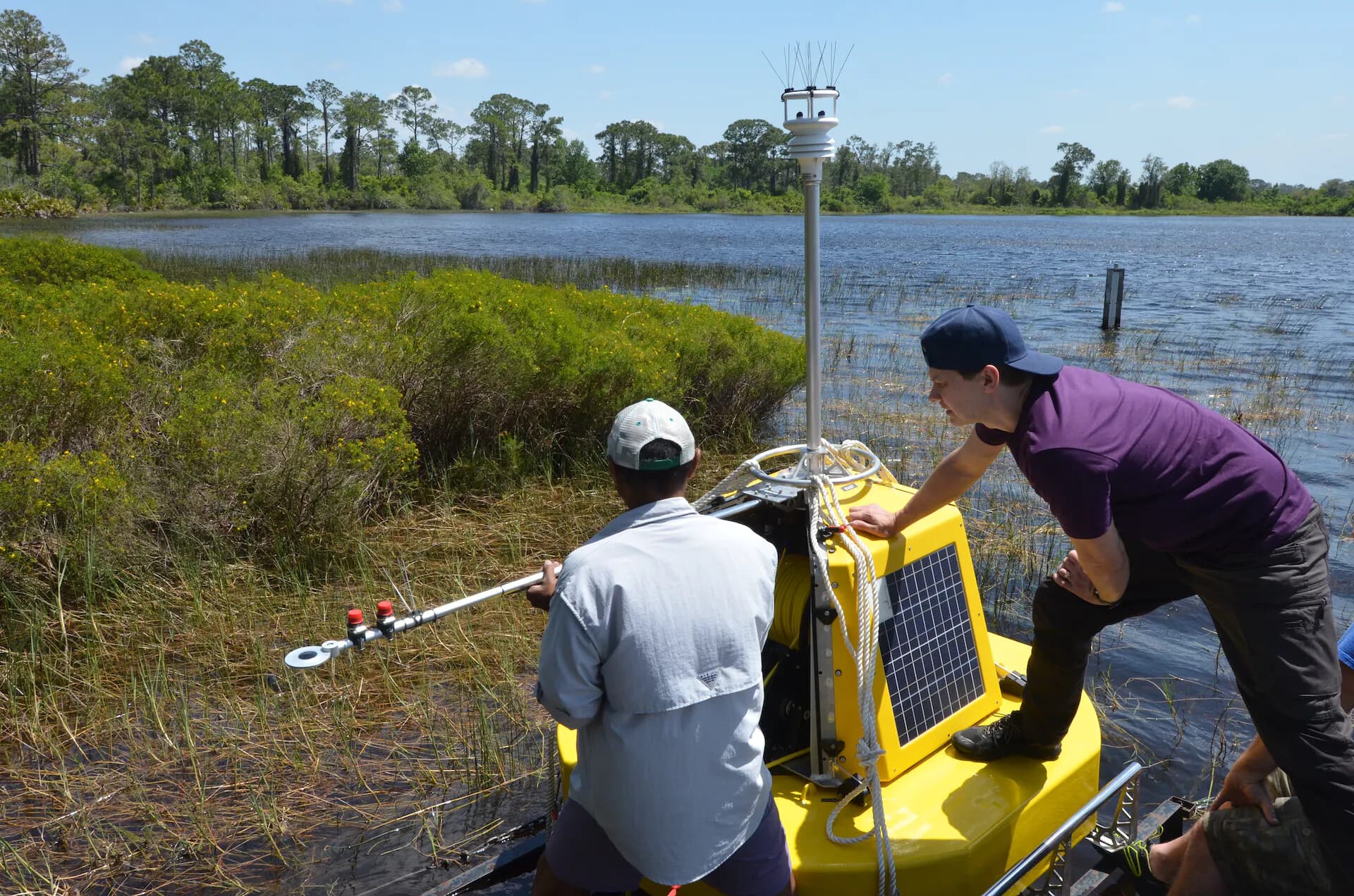 Deployment of Lake Annie buoy April 2022. Dr Amartya Saha Archbold instrumentation specialist with Andri Laidre, Owner of Flydog. Photo by Gabe Kamener (FIU).